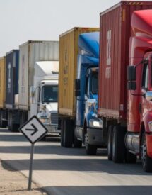 Digital illustration of U.S.–Mexico border logistics with trucks at customs and visual symbols of trade flow.