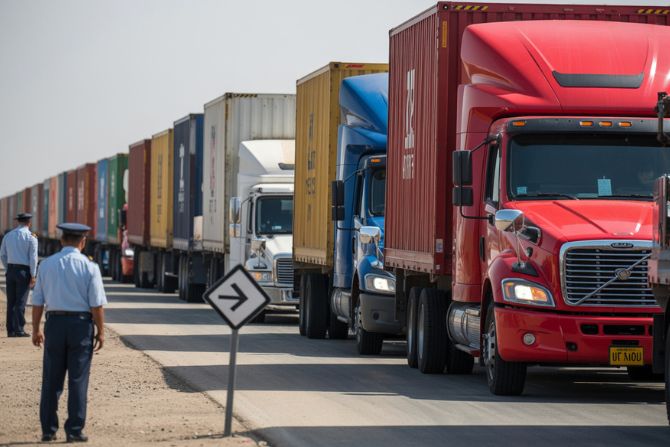 Digital illustration of U.S.–Mexico border logistics with trucks at customs and visual symbols of trade flow.
